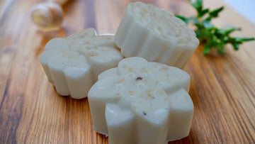 a couple of soaps sitting on top of a wooden table