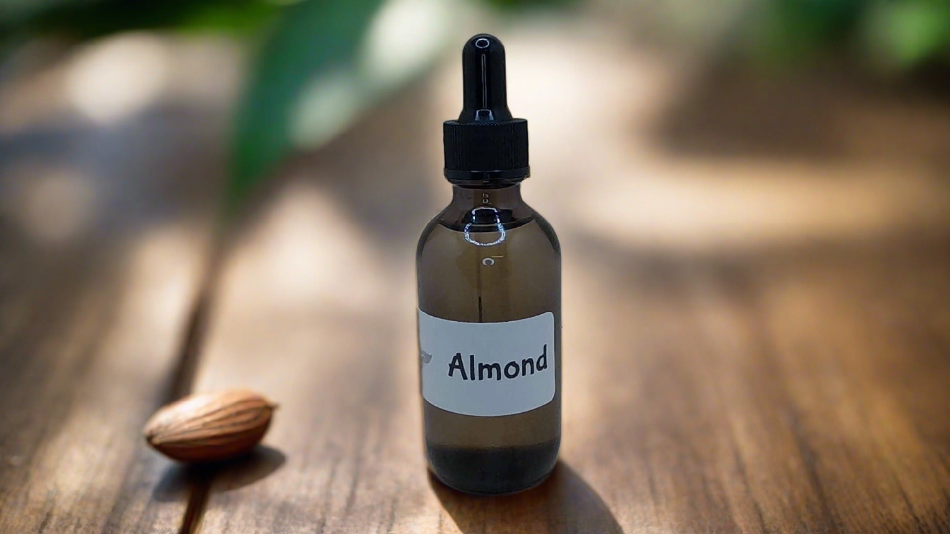 a bottle of almond oil sitting on a wooden table