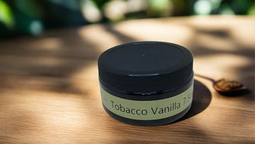 a jar of tobacco sitting on top of a wooden table