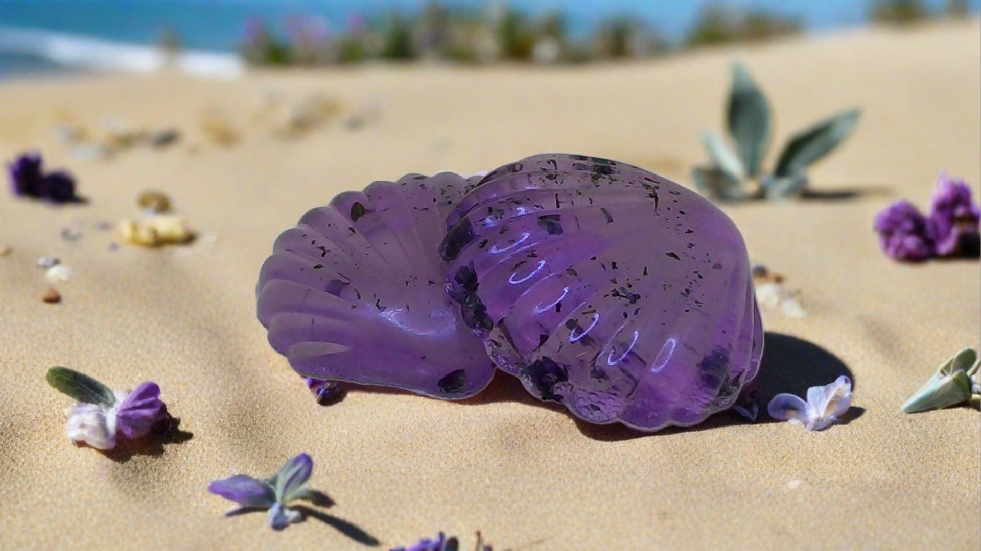 a purple object sitting on top of a sandy beach