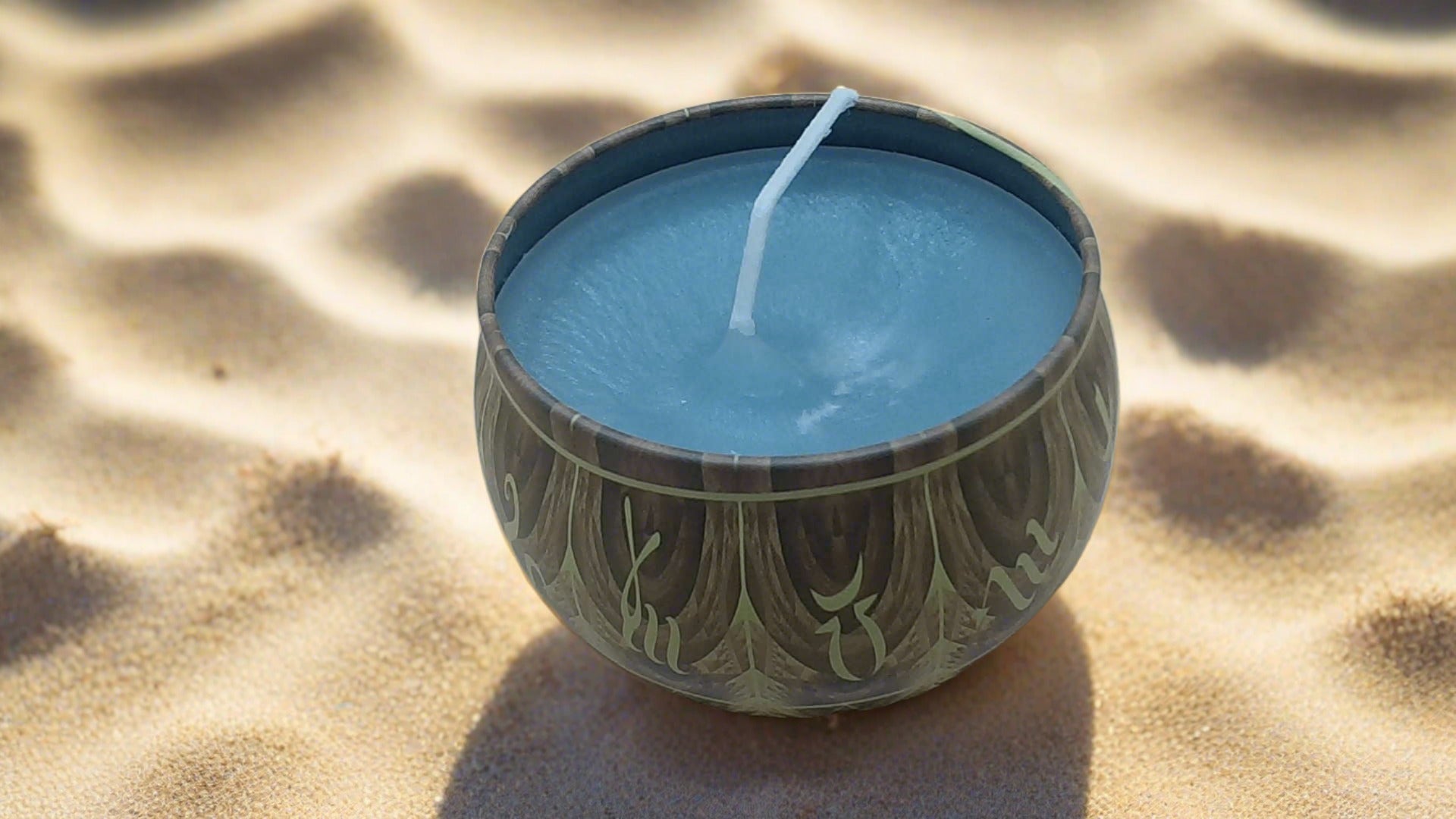 a candle that is sitting in the sand