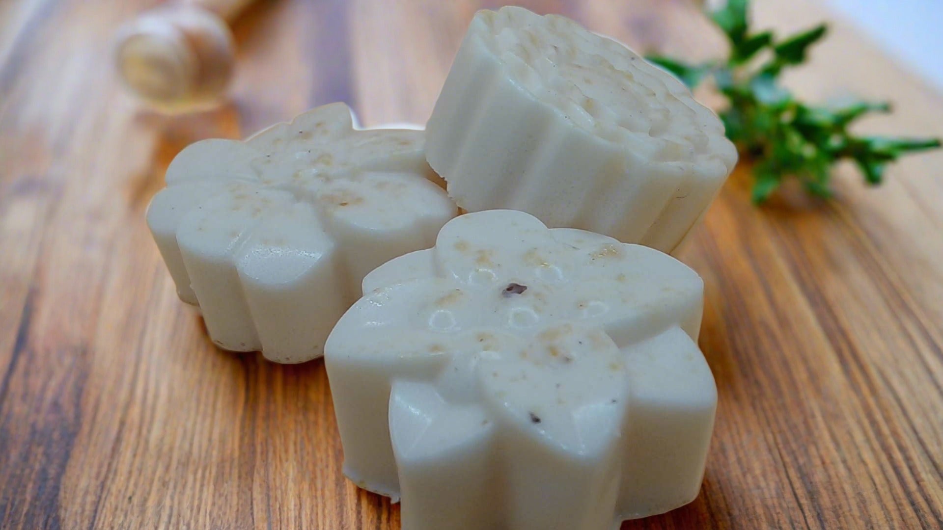 a couple of soaps sitting on top of a wooden table