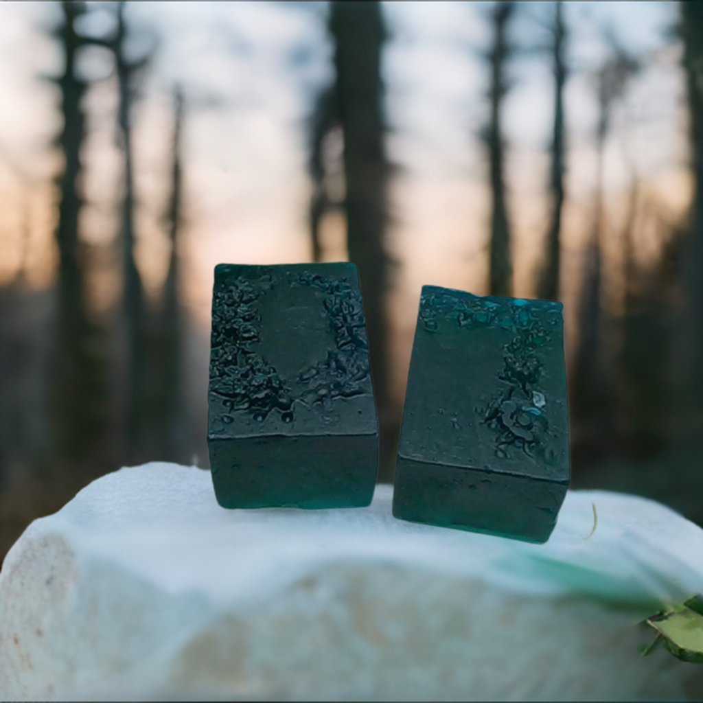 a couple of soaps sitting on top of a rock