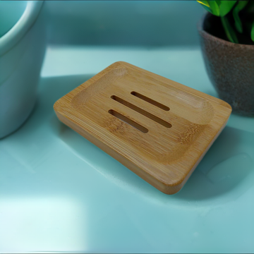 a wooden cutting board sitting next to a potted plant