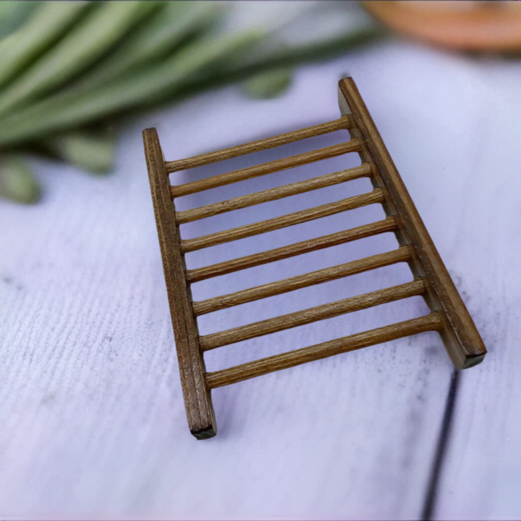 a wooden soap dish sitting on top of a white table