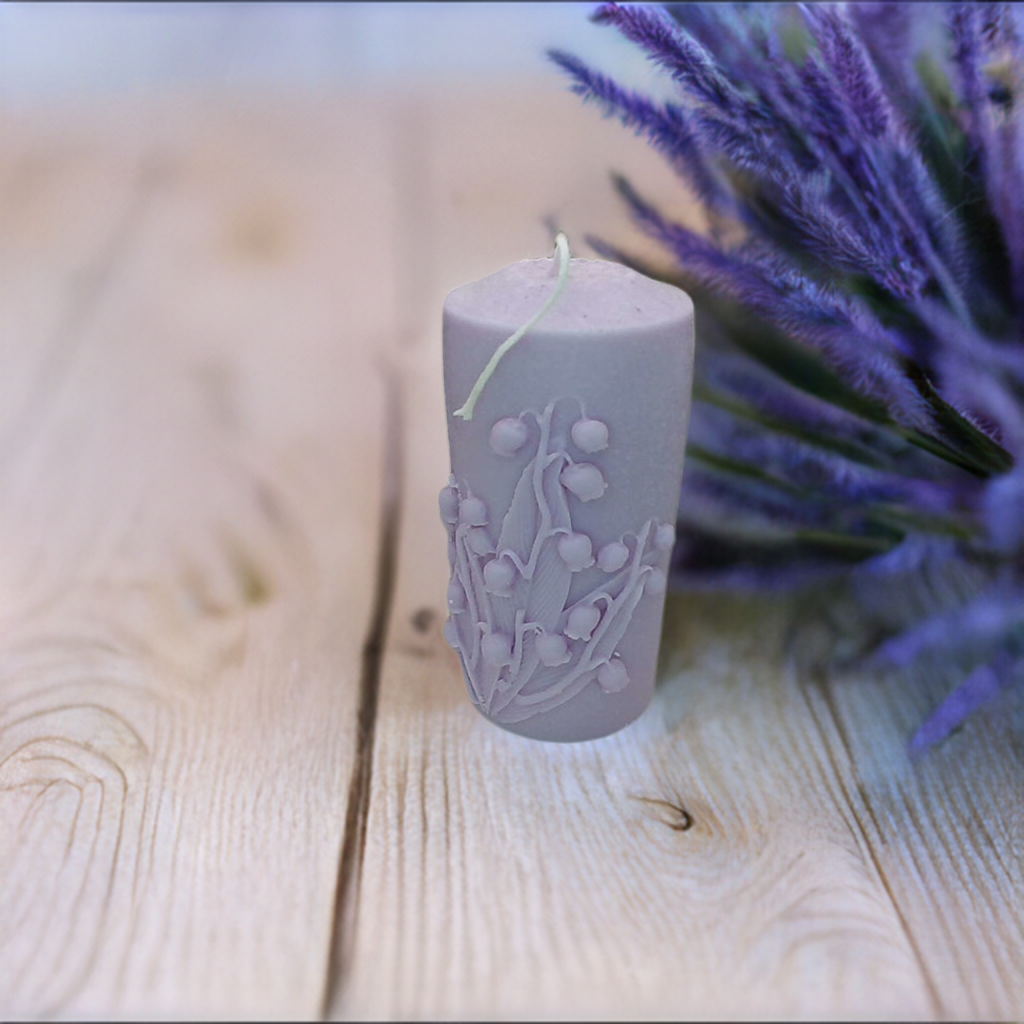 a purple candle sitting on top of a wooden table