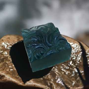 a soap bar sitting on top of a piece of gold foil