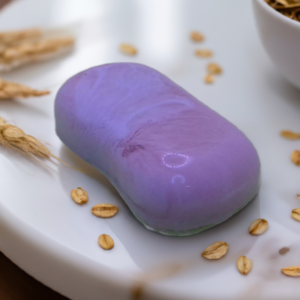 a white soap topped with a purple pastry next to a bowl of oats