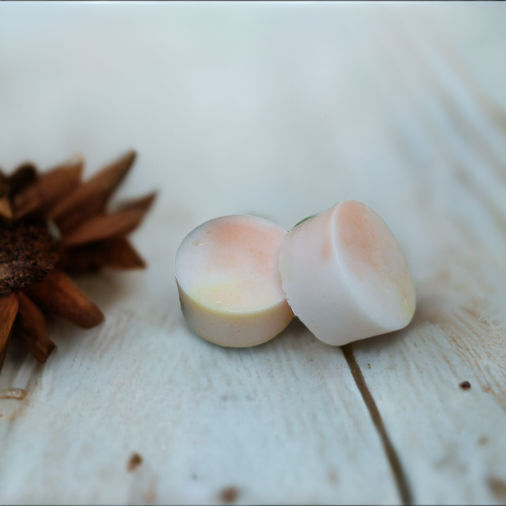 a couple of pieces of soap sitting next to a flower