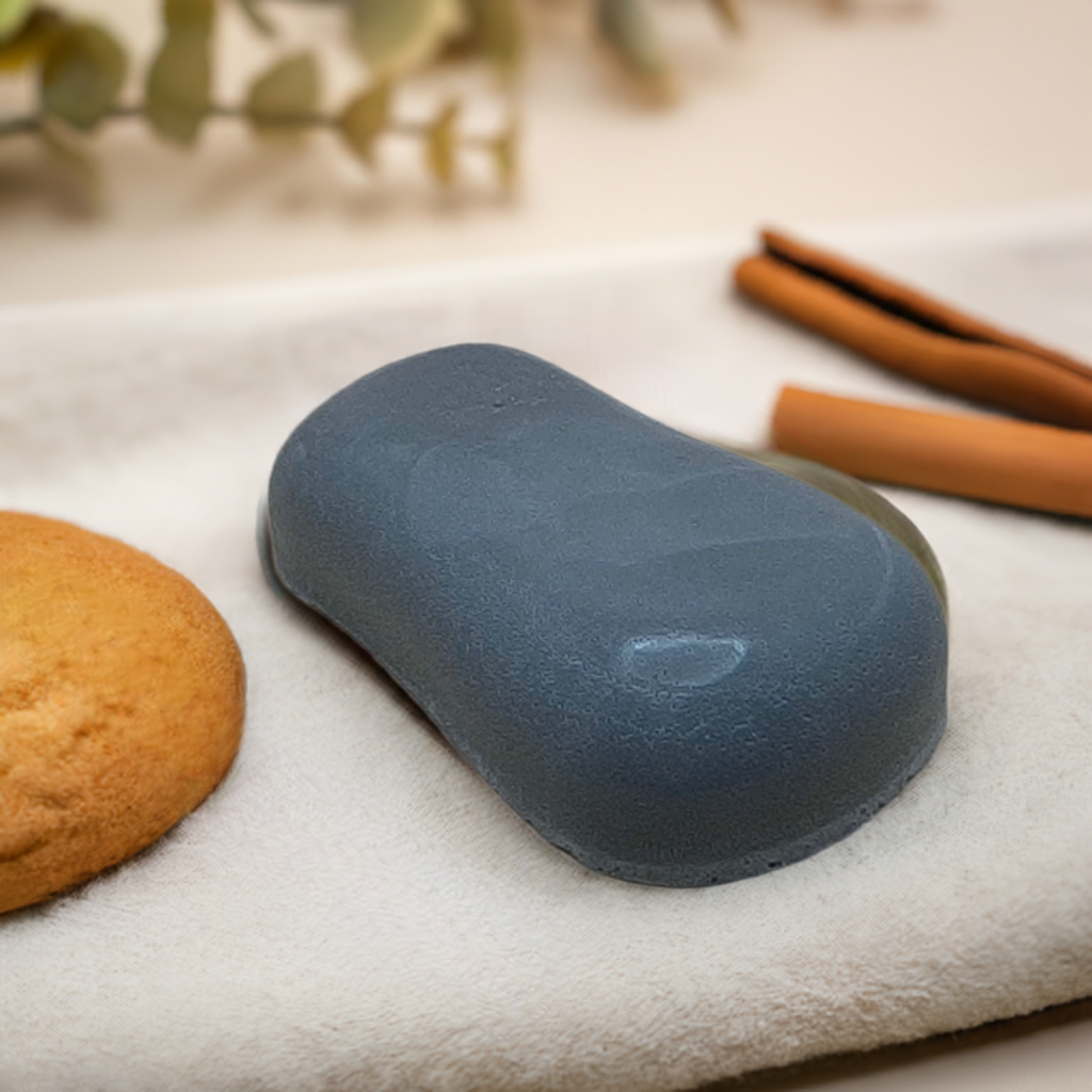 a blue object sitting on top of a towel next to a cookie