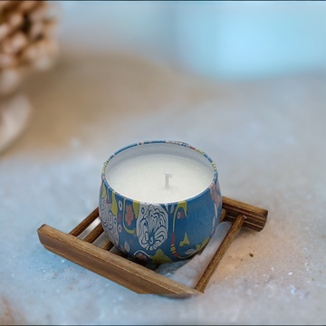 a candle sitting on top of a wooden tray