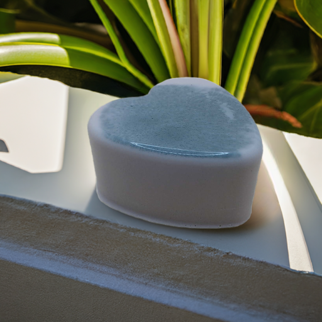 a blue heart shaped object sitting on top of a table