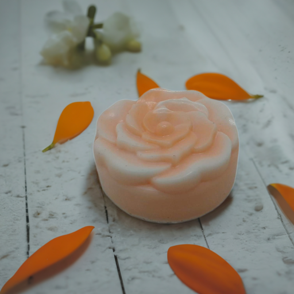 a soap with a rose on top of it