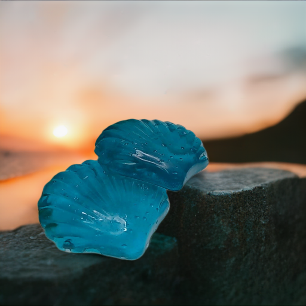 a blue glass object sitting on top of a rock