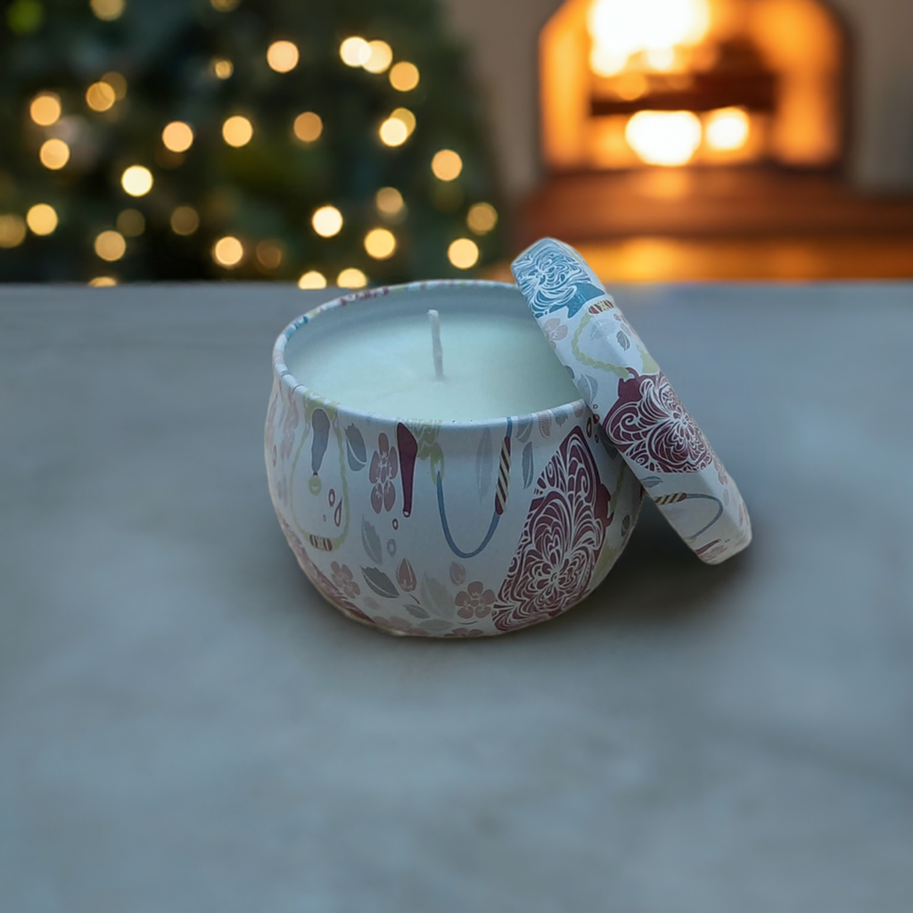 a candle sitting on a marble table with Christmas tree in the background