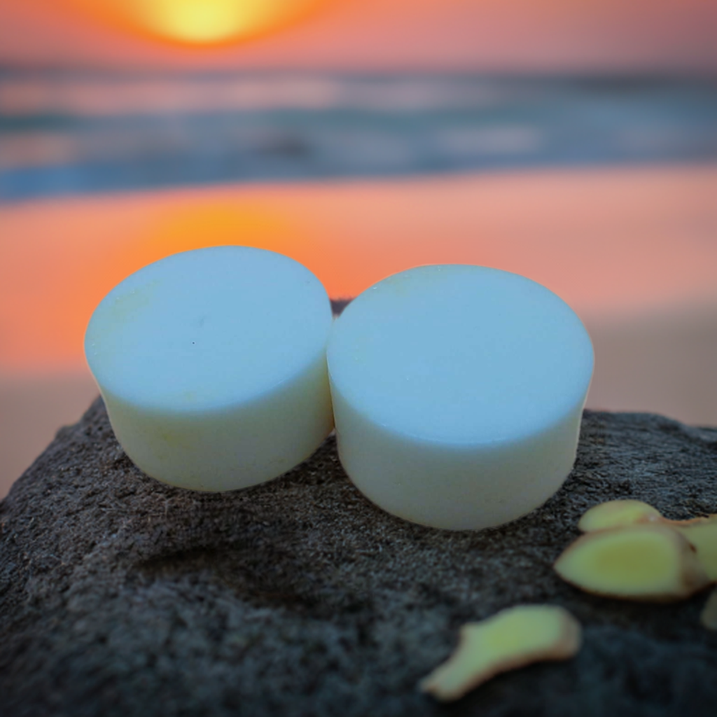 two soap bars sitting on top of a rock