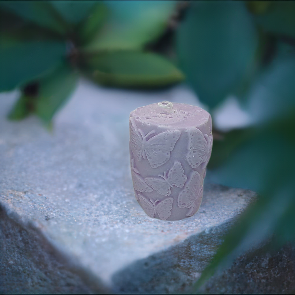 a pink vase sitting on top of a rock