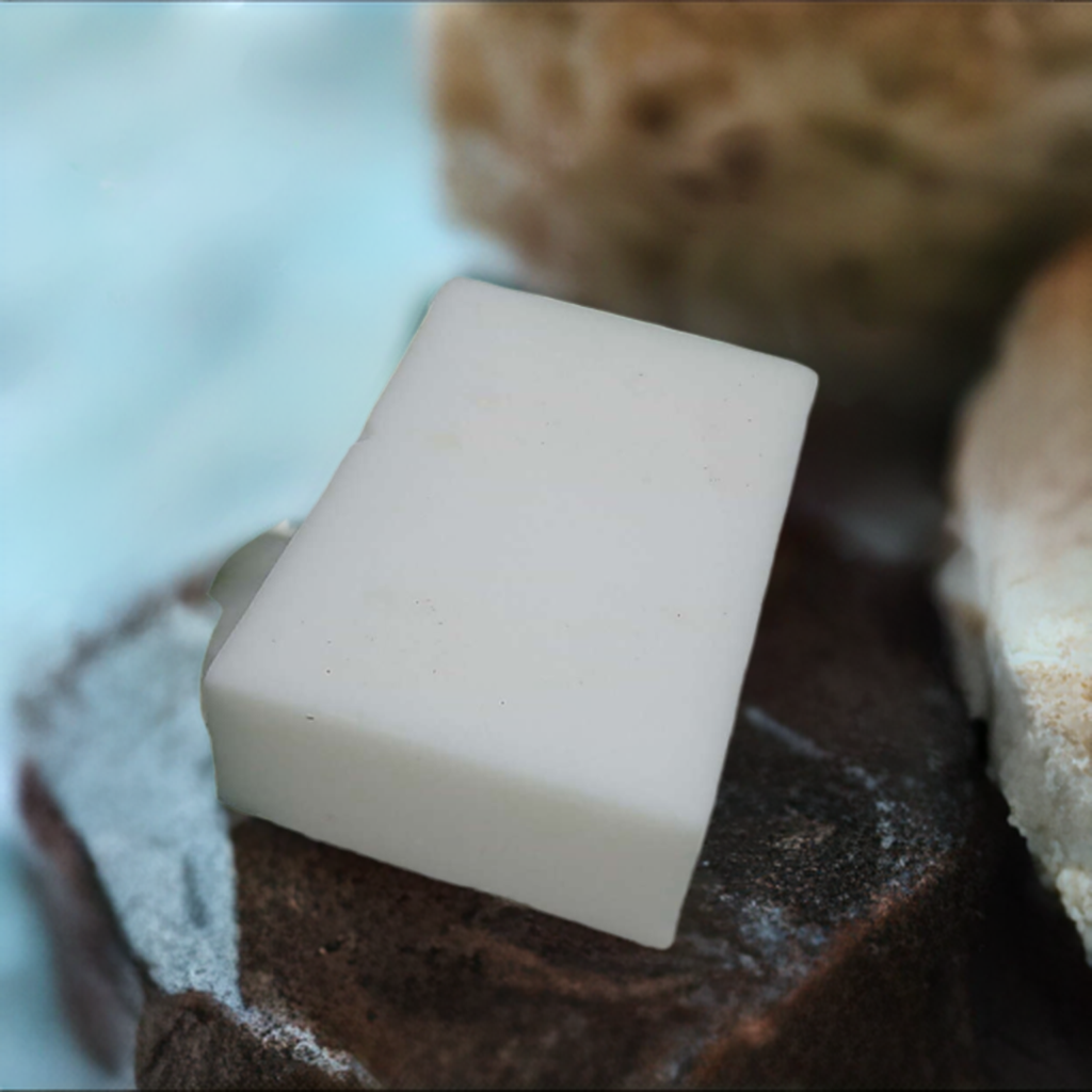 a bar of soap sitting on top of a piece of chocolate