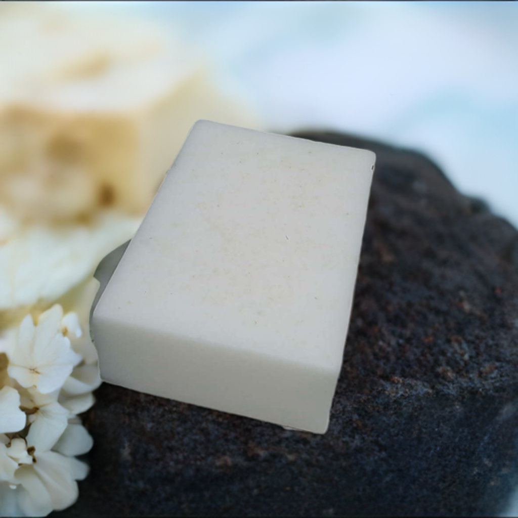 a piece of soap sitting on top of a piece of cake