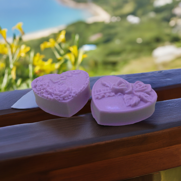 a couple of soaps sitting on top of a wooden table