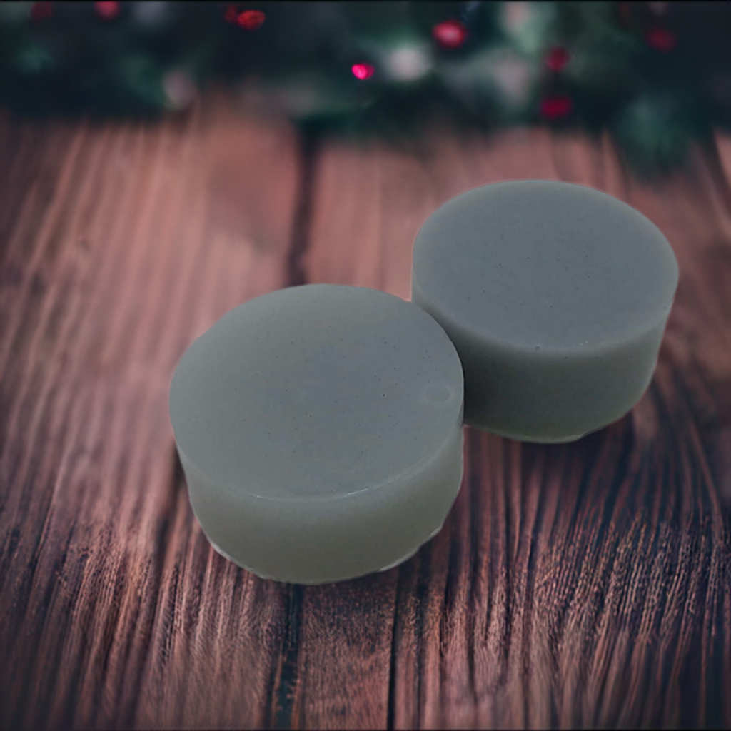 a couple of soaps sitting on top of a wooden table