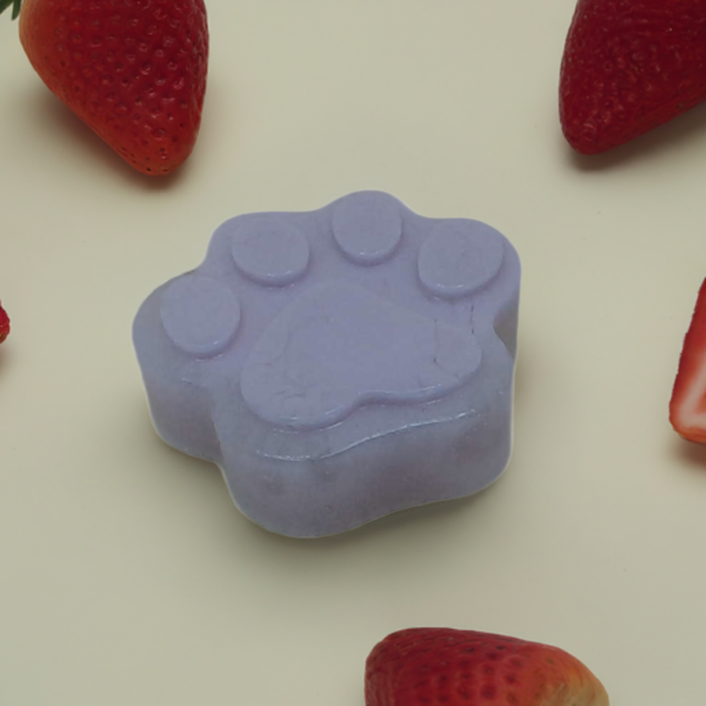 a close up of a soap on a table with strawberries