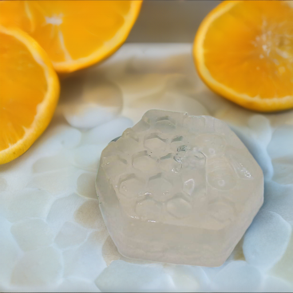 a close up of a piece of ice with oranges in the background