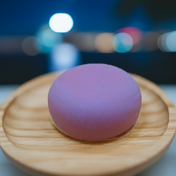 a round object sitting on top of a wooden plate