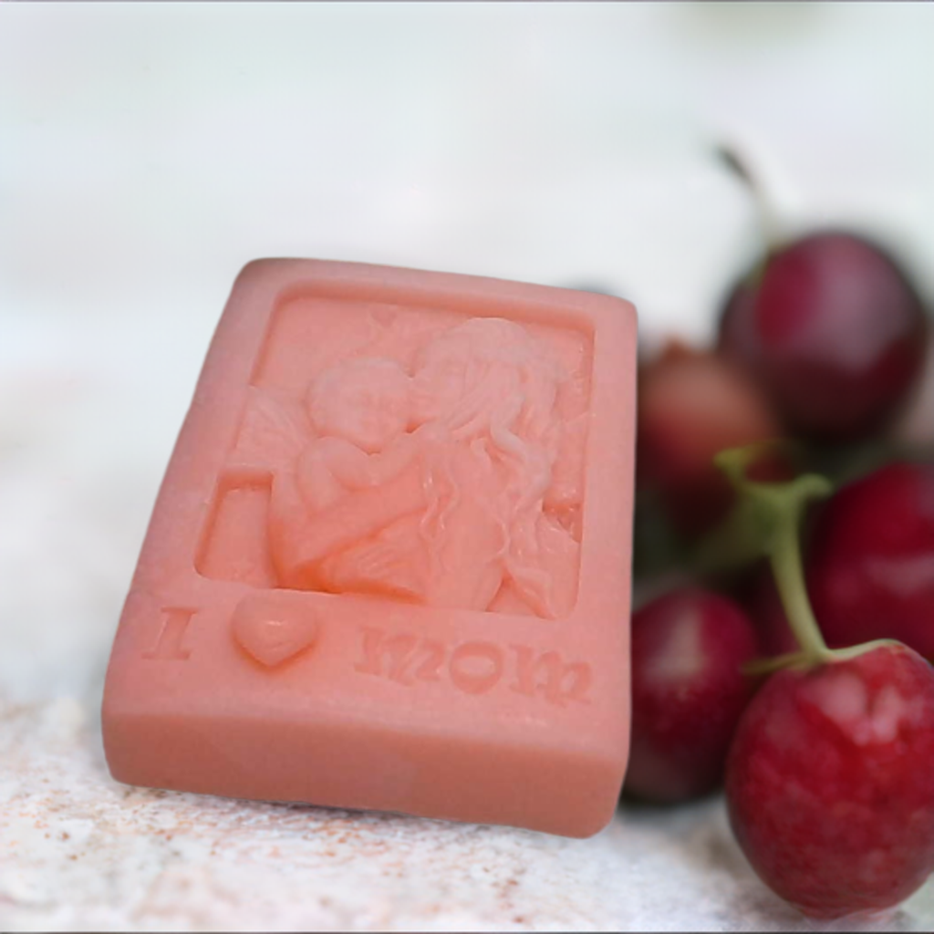 a soap bar sitting next to a bunch of cherries