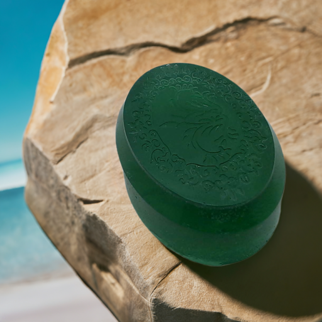 a green object sitting on top of a rock near the ocean