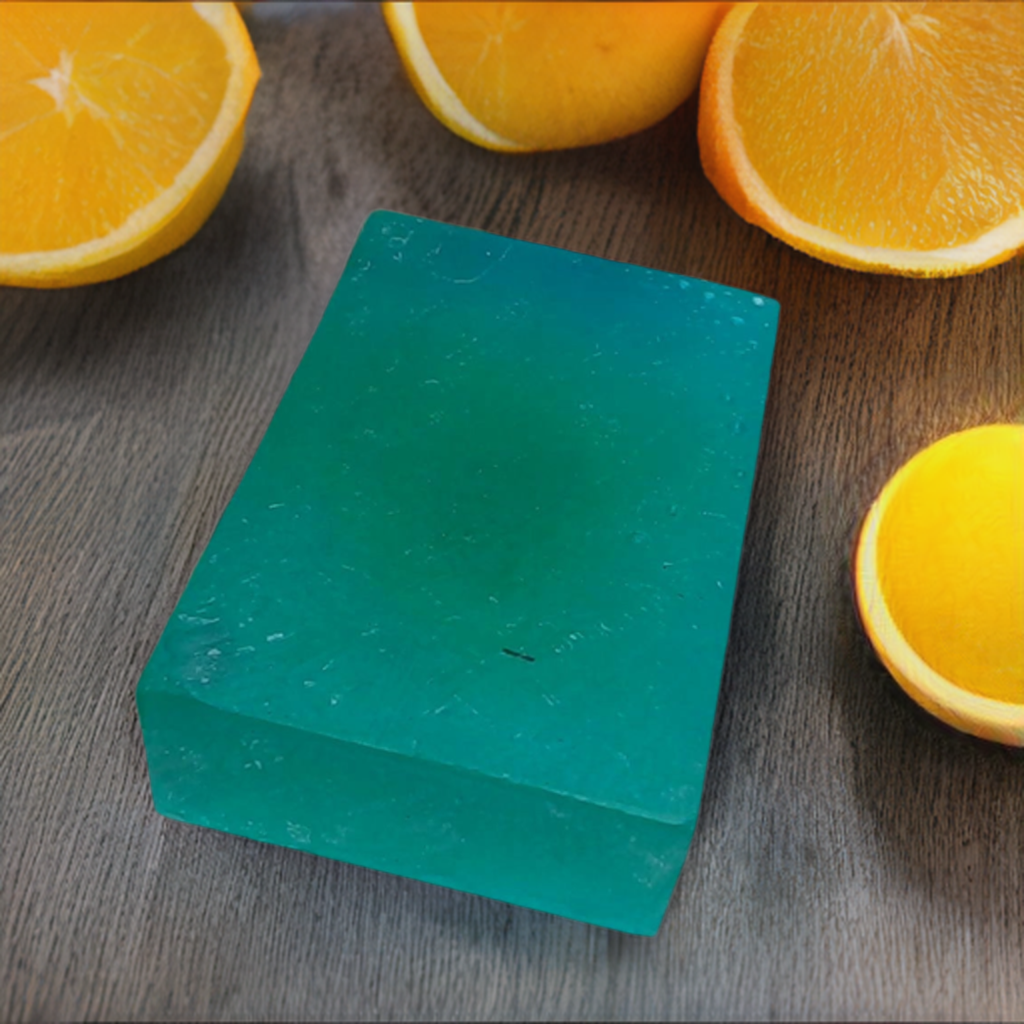 a green block of soap surrounded by oranges