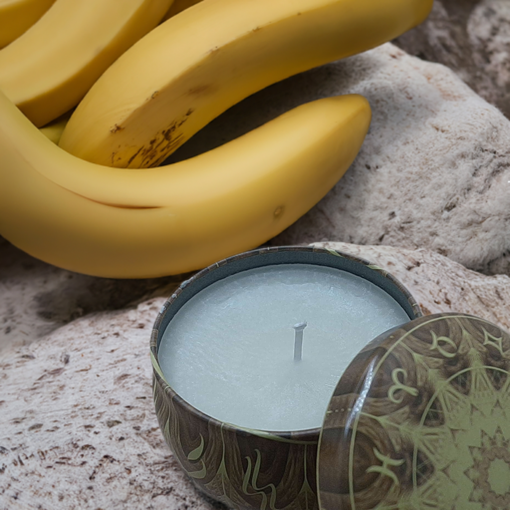 a candle sitting next to a bunch of bananas