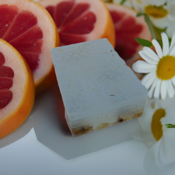 a close up of a grapefruit and a piece of soap