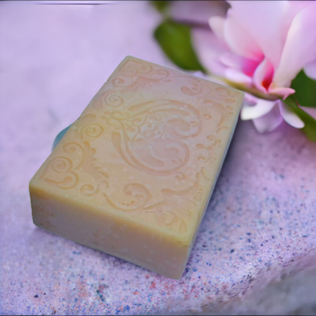 a soap bar sitting on top of a pink flower