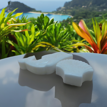 a couple of pieces of white soap sitting on top of a table