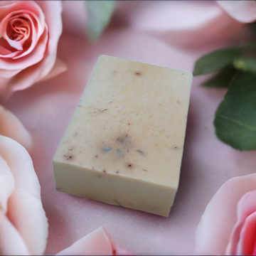 a bar of soap sitting on top of pink flowers