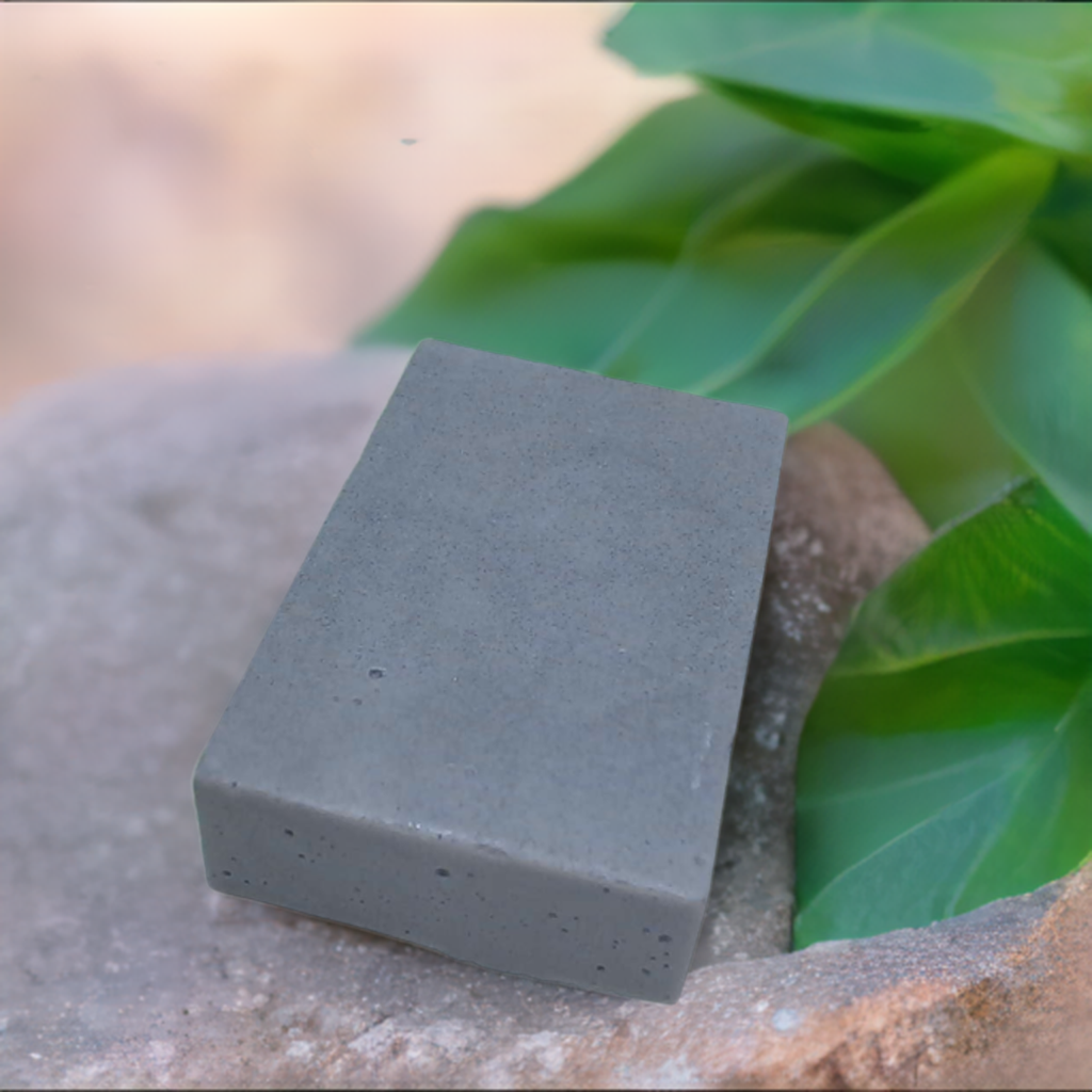 a gray block of soap sitting on top of a rock