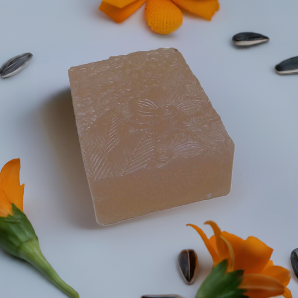 a soap bar sitting on top of a table next to flowers