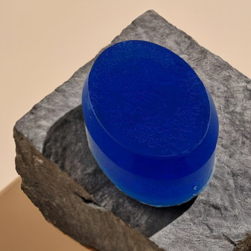 a blue soap sitting on top of a rock